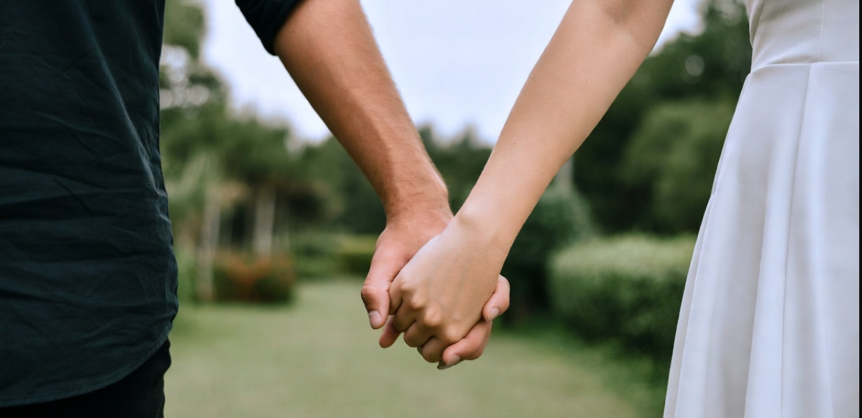 Couple holding hands together and talking
